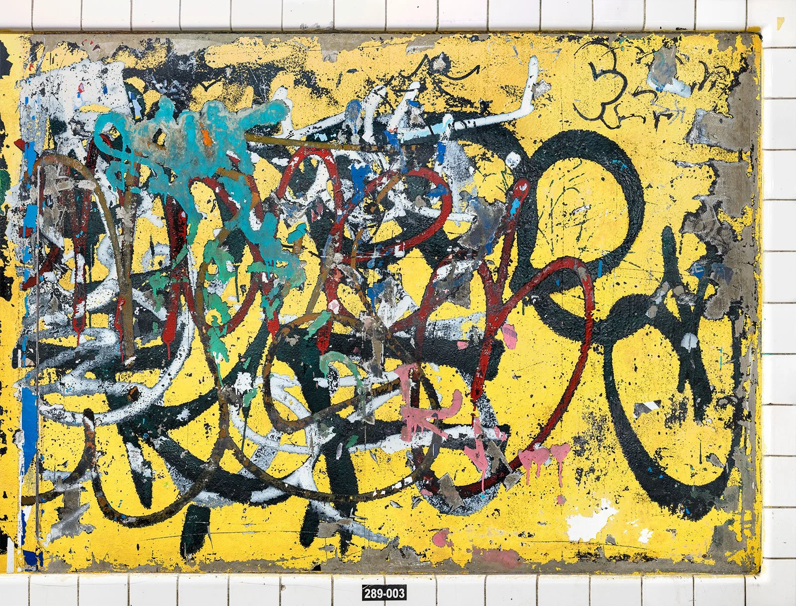A photograph of a New York City subway advertising panel, showcasing urban decay transformed into fine art. Photographed by Barton Lewis, the image focuses on minimalist, painterly textures, poster fragments, heavily scraped surfaces and faded pigmen