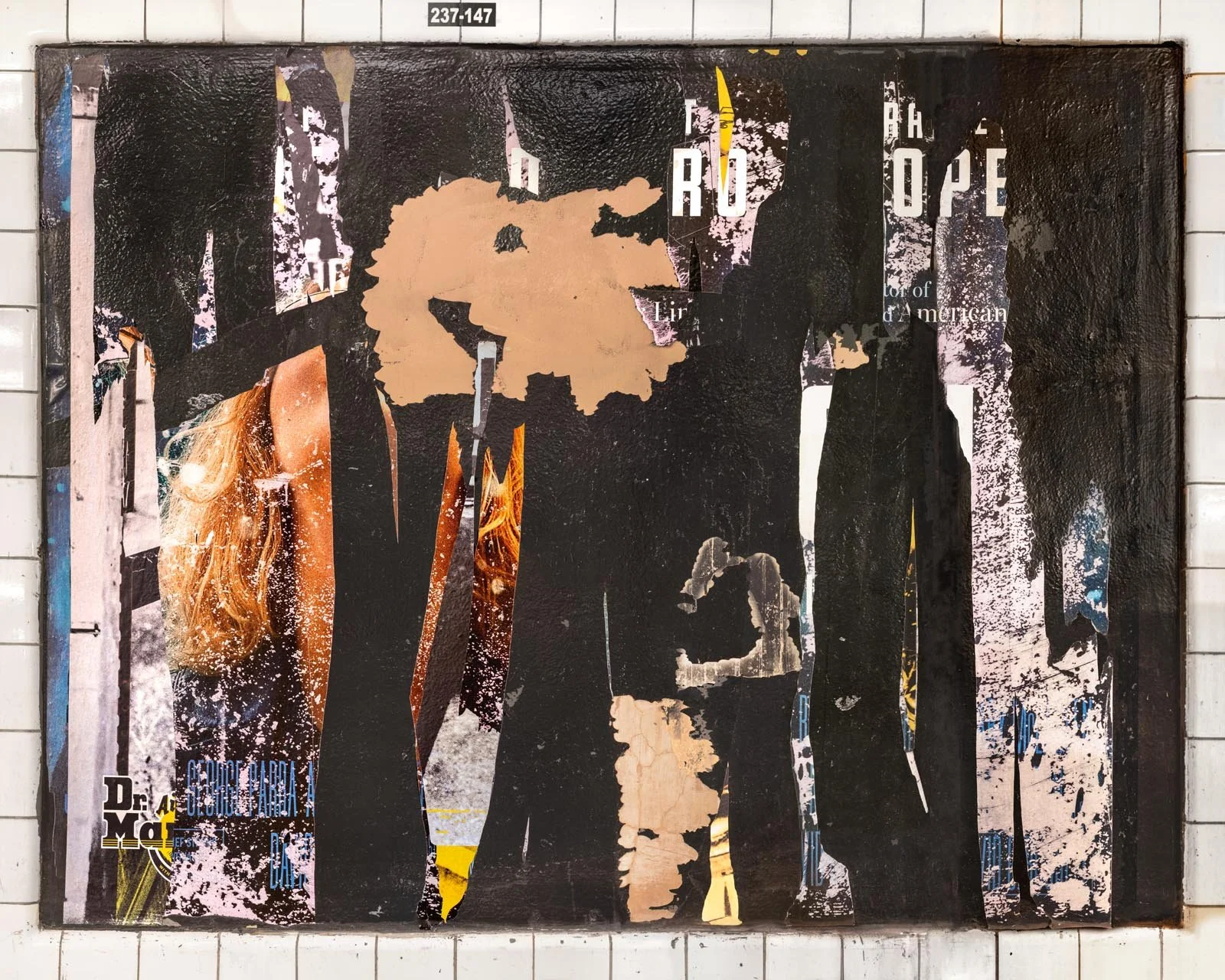 A photograph of a New York City subway advertising panel, showcasing urban decay transformed into fine art. Photographed by Barton Lewis, the image focuses on minimalist, painterly textures, poster fragments, heavily scraped surfaces and faded pigmen