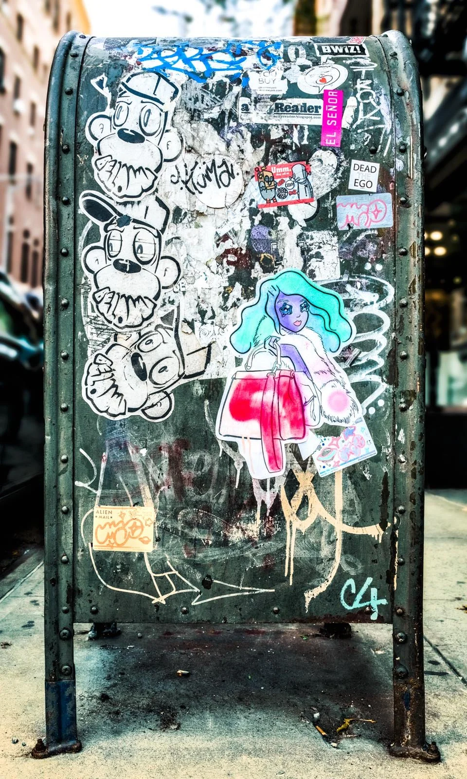 Fine art urban photography print of a public New York City mailbox covered in sticker slaps and graffiti. This photograph of street art collage is captured by contemporary photographer Barton Lewis.