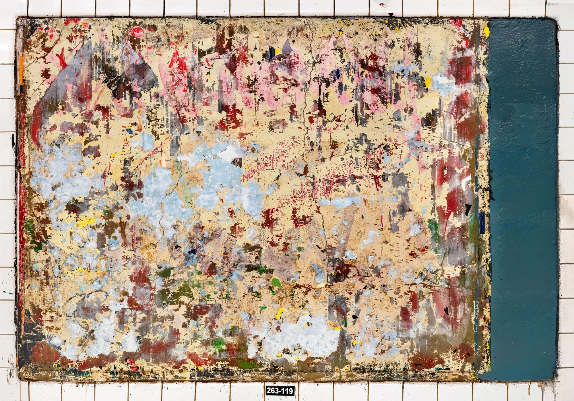 Fine art urban photography of a scraped subway panel resembling an abstract expressionist painting. This organic composition features layers of chipped paint, fragments of torn posters and graffiti, captured by Barton Lewis.