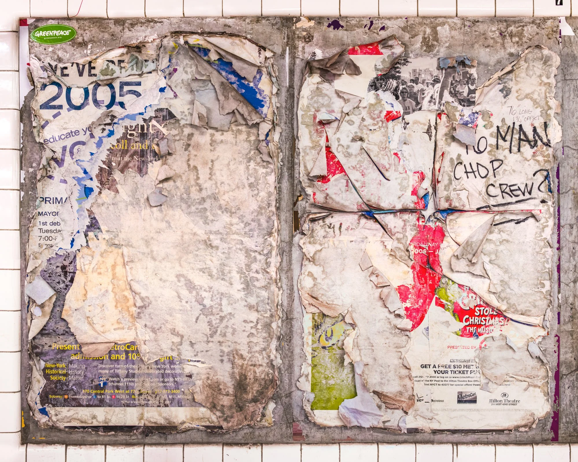 Fine art urban photography of a scraped subway panel resembling an abstract expressionist painting. This organic composition features layers of chipped paint, fragments of torn posters and graffiti, captured by Barton Lewis.