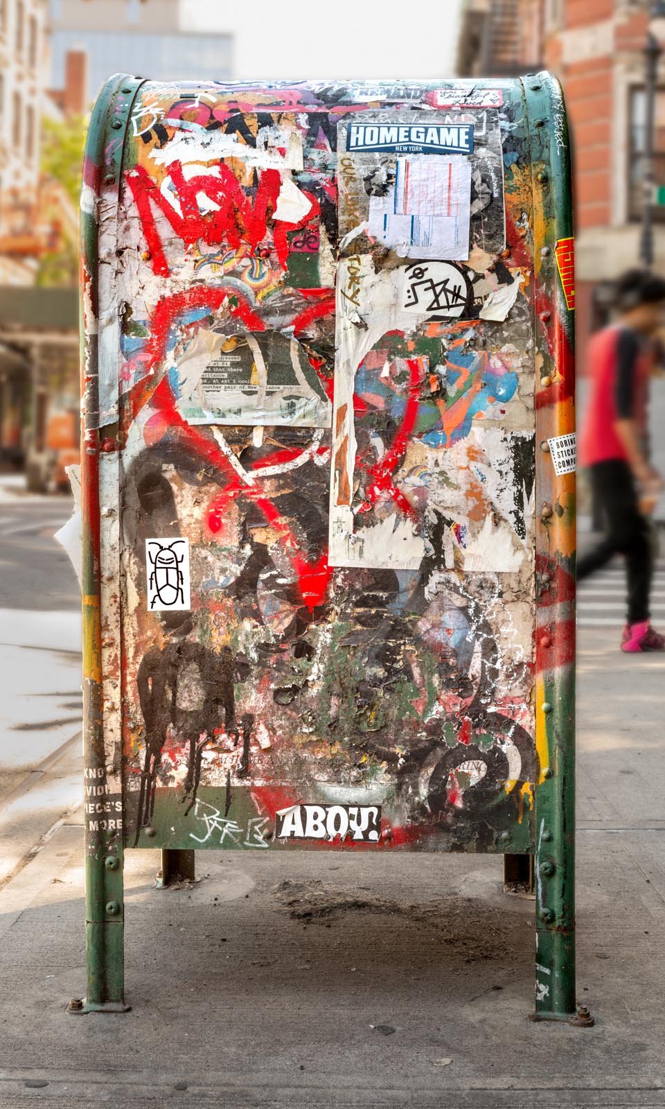 Fine art urban photography print of a public New York City mailbox covered in sticker slaps and graffiti. This photograph of street art collage is captured by contemporary photographer Barton Lewis.