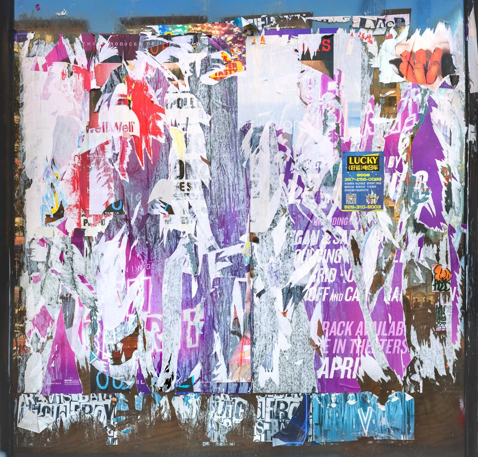 Fine art urban photography capturing decaying advertising posters on a plywood construction site fence. The composition isolates layers of shredded commercial paper, weathered textures, and accidental street art by Barton Lewis.