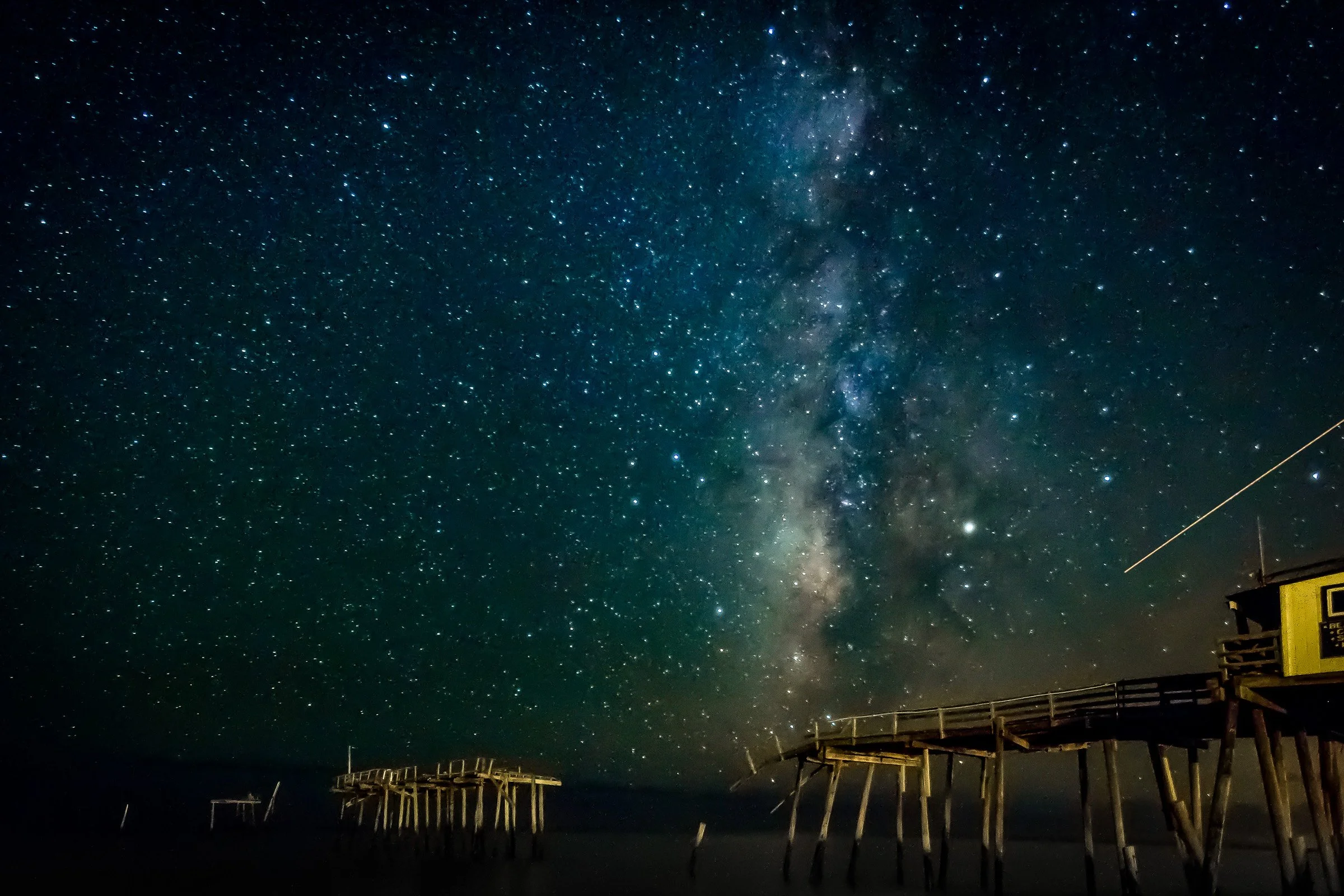 Milky Way over the remains of the old Frisco Pier at night in Frisco, North Carolina.