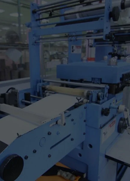 Industrial machine with a conveyor belt and metal rollers, likely used for manufacturing or packaging.