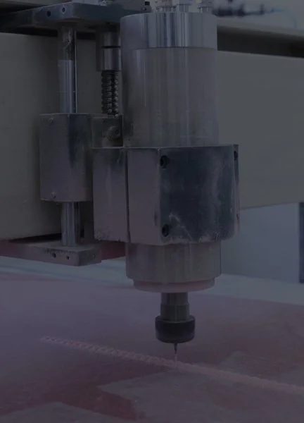 Close-up of an industrial CNC machine extract with a rotating tool on a workpiece.