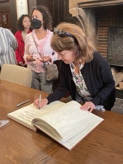 Mom signing town's golden book