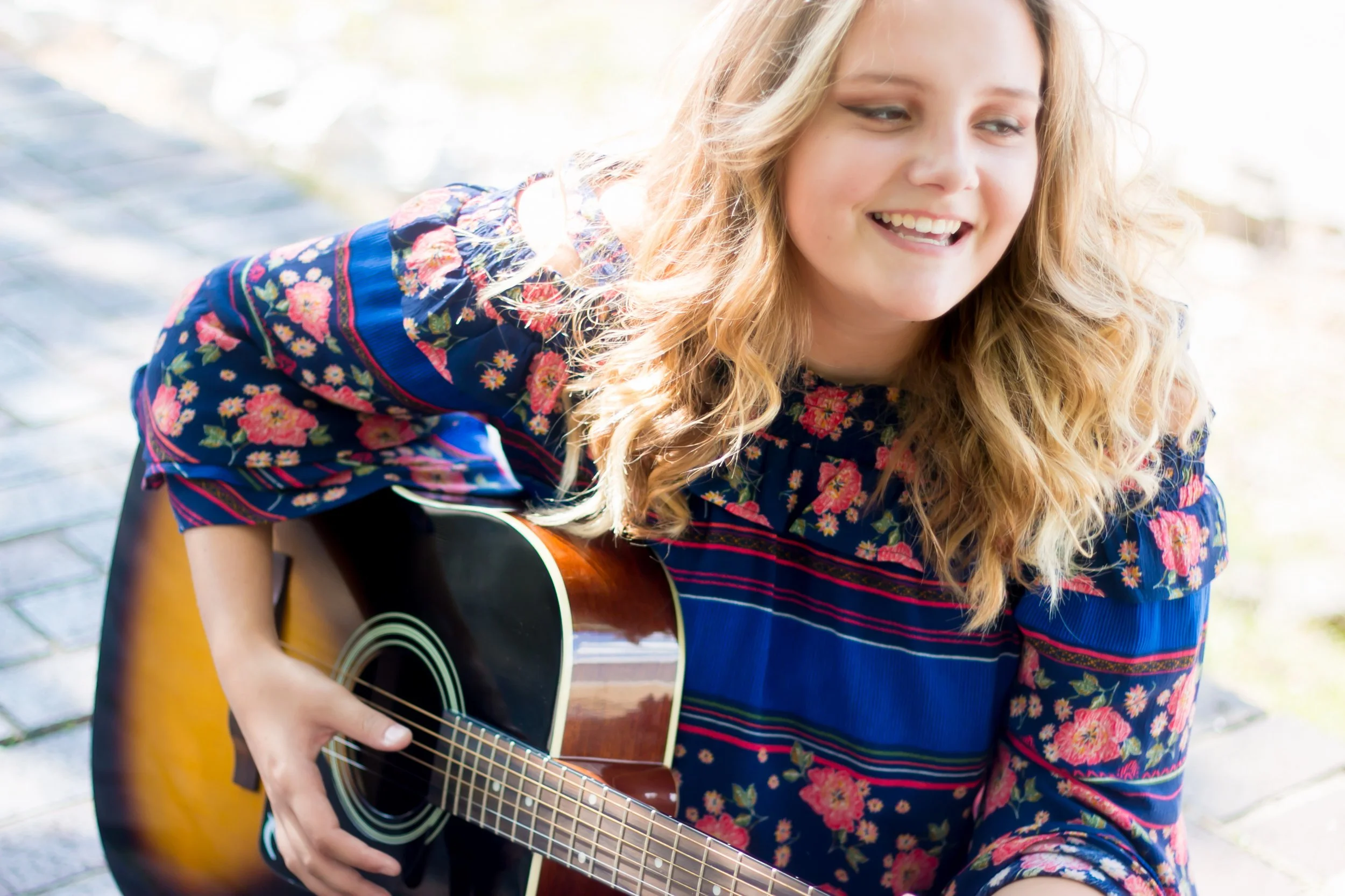 Personalized senior portrait featuring a meaningful prop during a creative senior session at Say Yes to Jess in Cincinnati