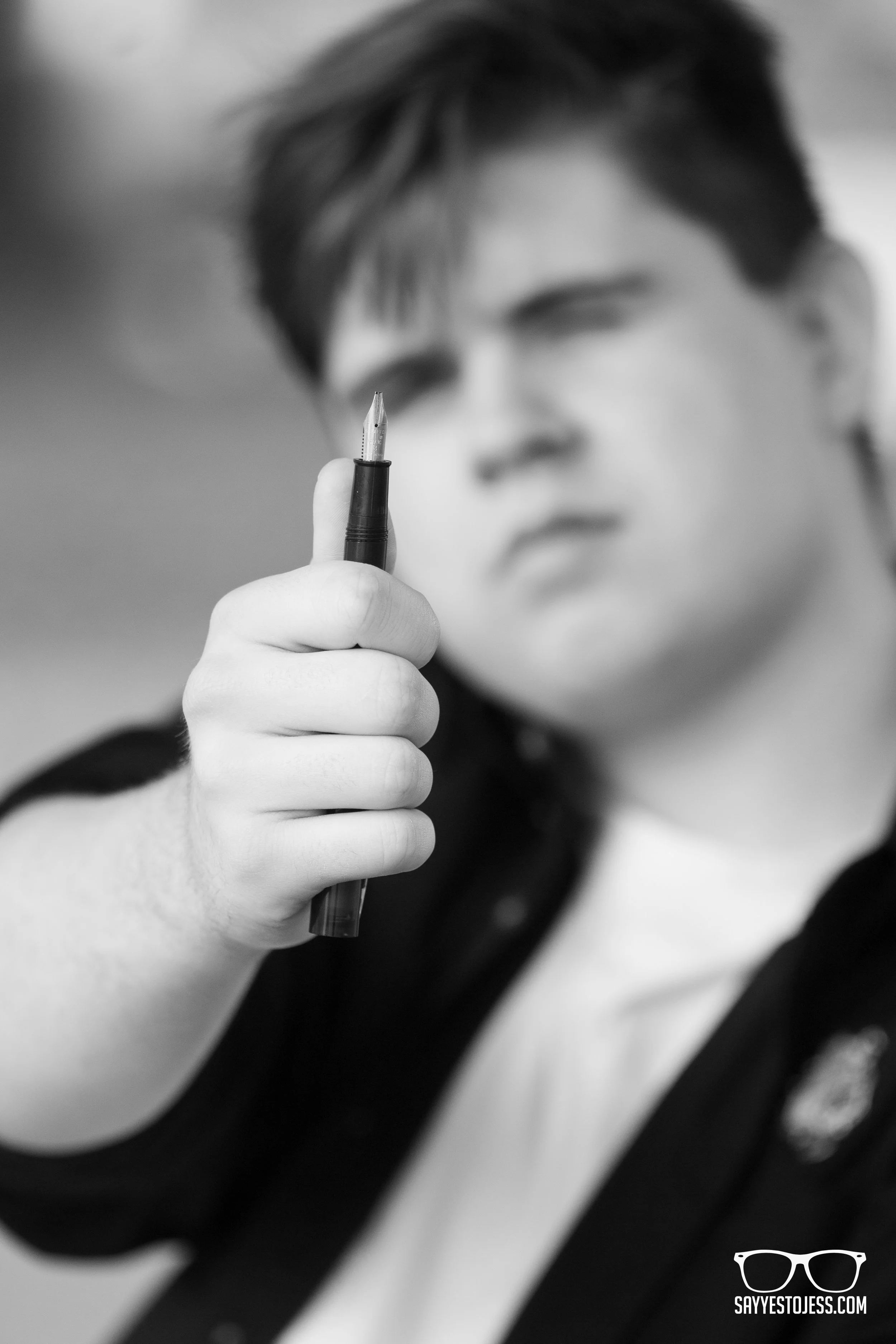 Senior showing off his love of calligraphy for senior photos