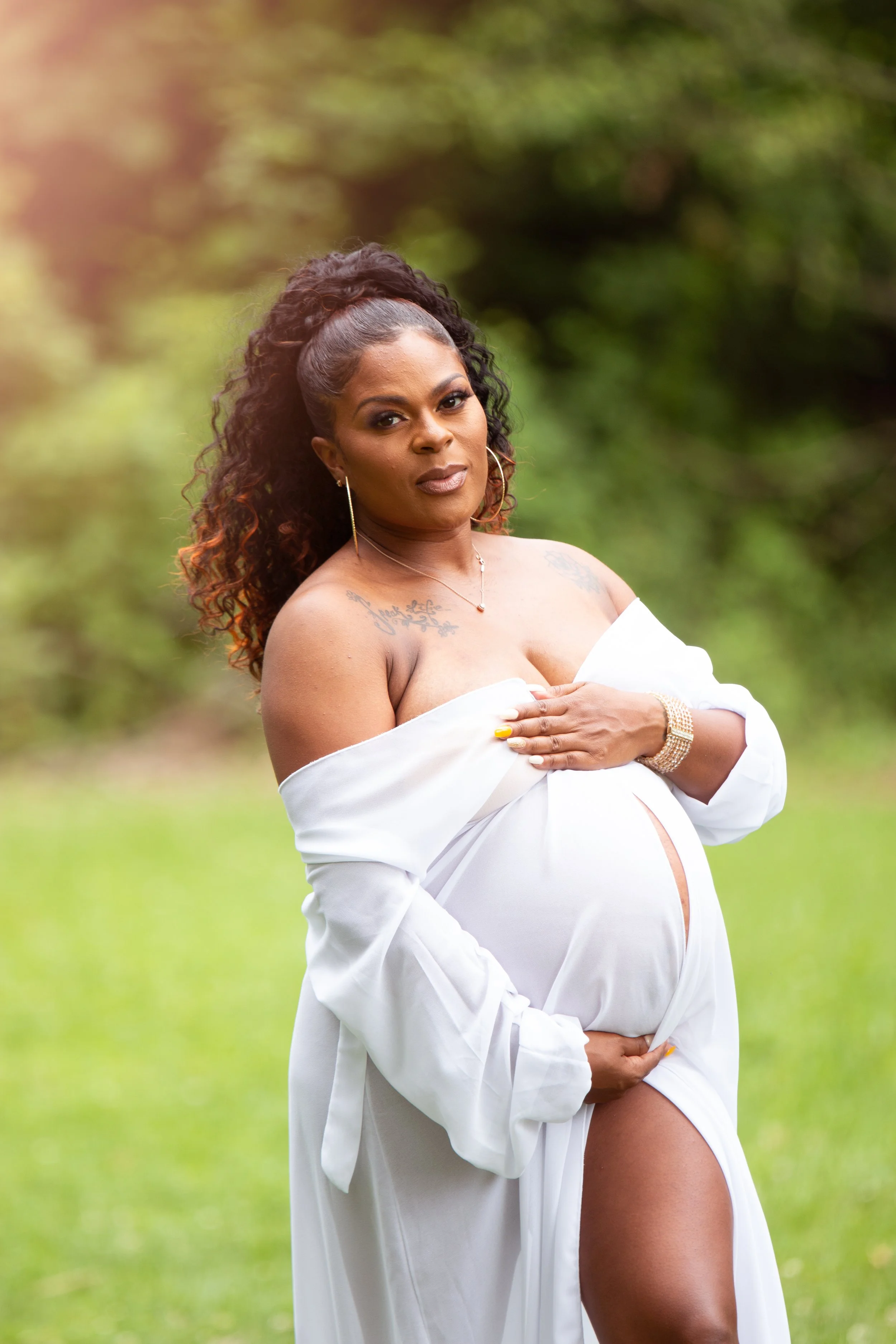 Outdoor maternity photoshoot at Devou Park in Northern Kentucky with expecting mom in flowing dress