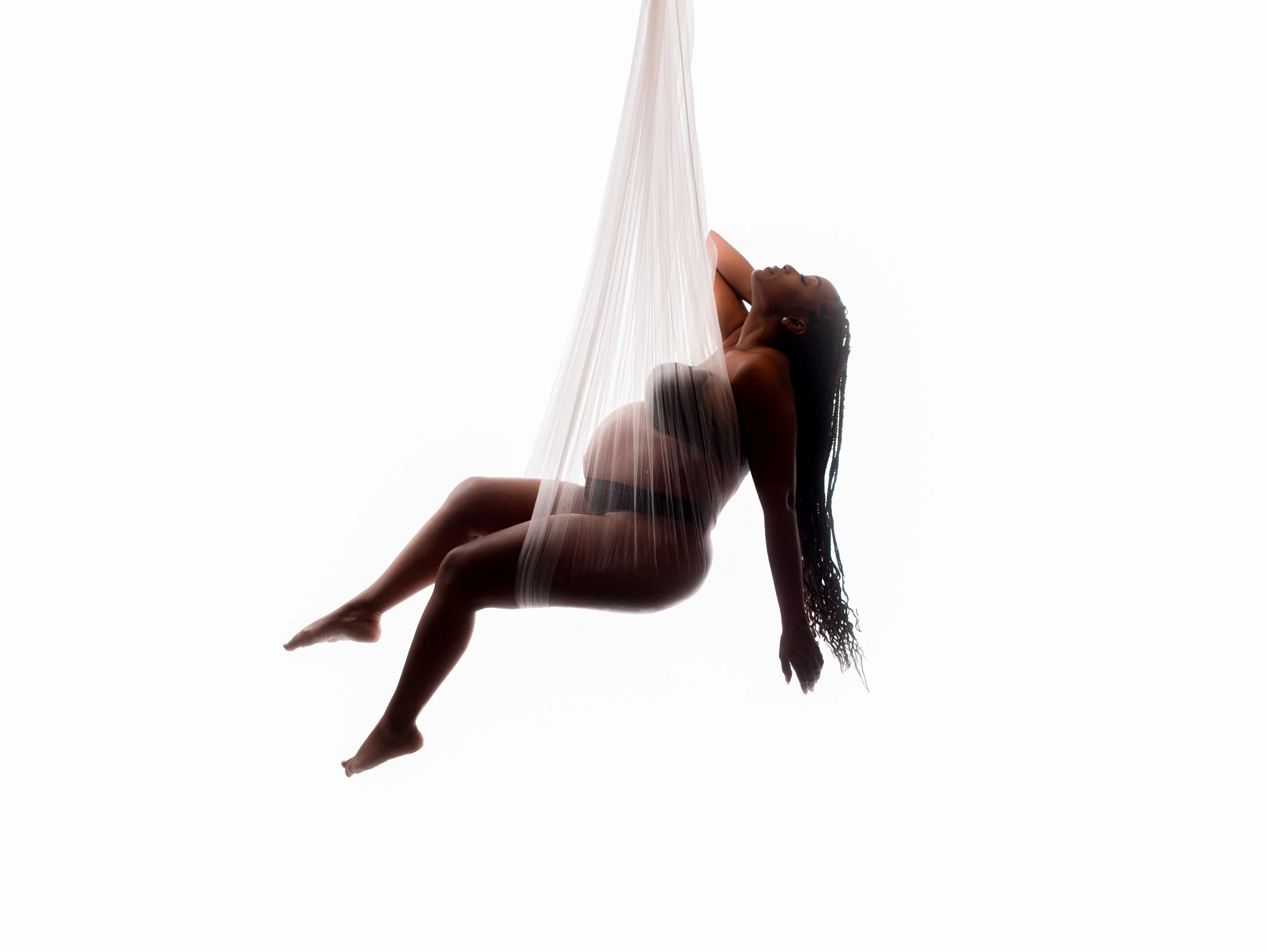 Maternity swing portrait of expecting mother draped in sheer fabric at Say Yes to Jess Cincinnati studio