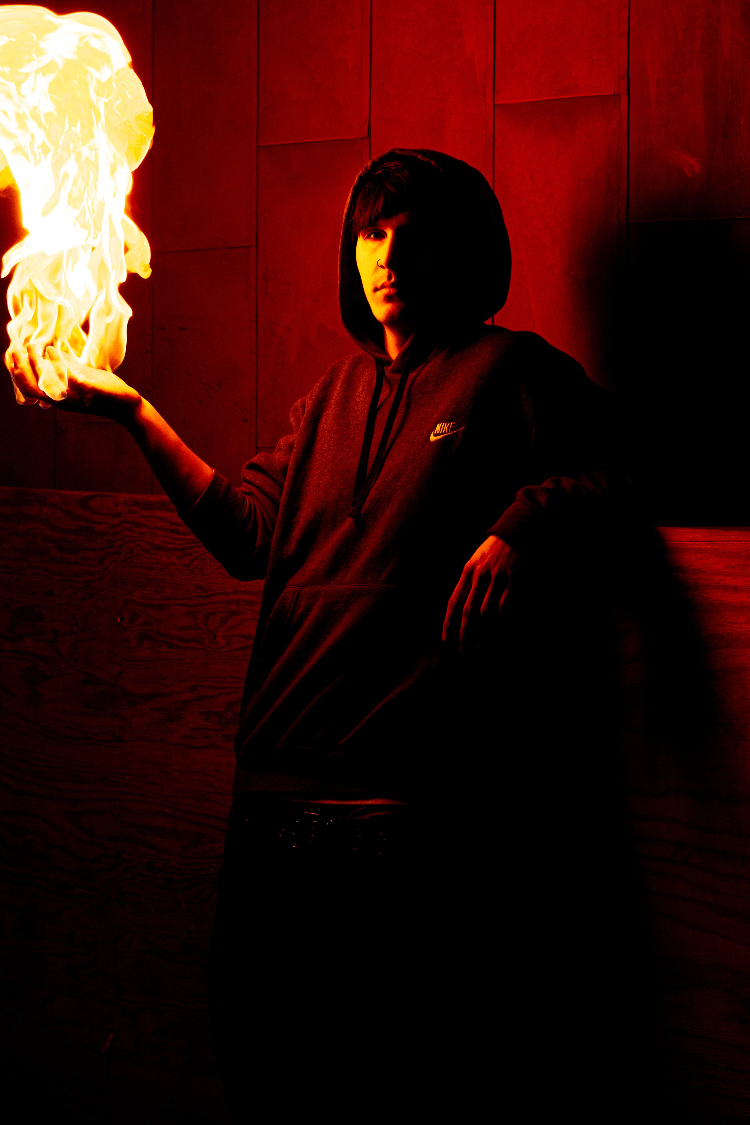 Senior photo session of guy holding fire