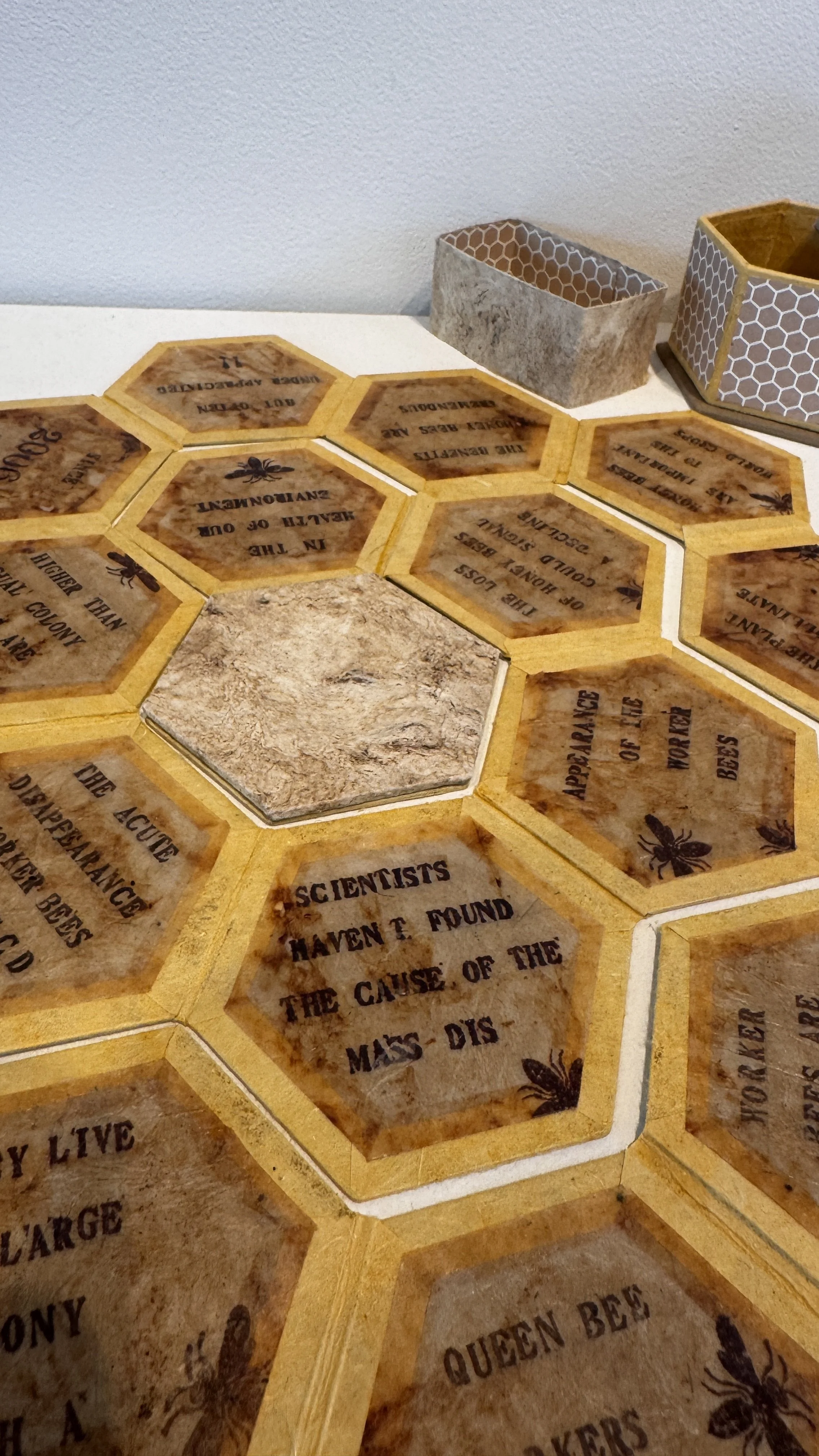  Naomi Kasumi,   Home sweet homE, 2nd Edition  , 2018. Tea-bag, Bee's wax, decorative paper, Mexican bark paper, binding board, Rubber letter and bee image stamps, ink. Price 