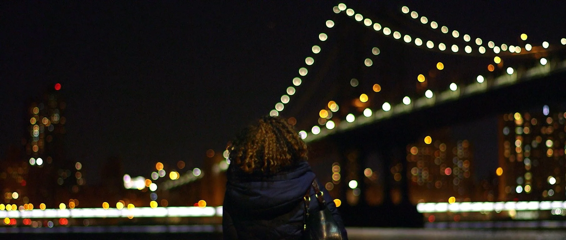 Girl walking near bridge at night time.jpg