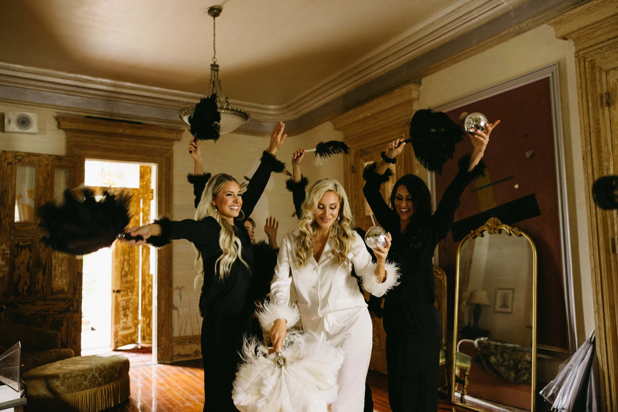 Bride dancing in pajamas with her bridesmaids