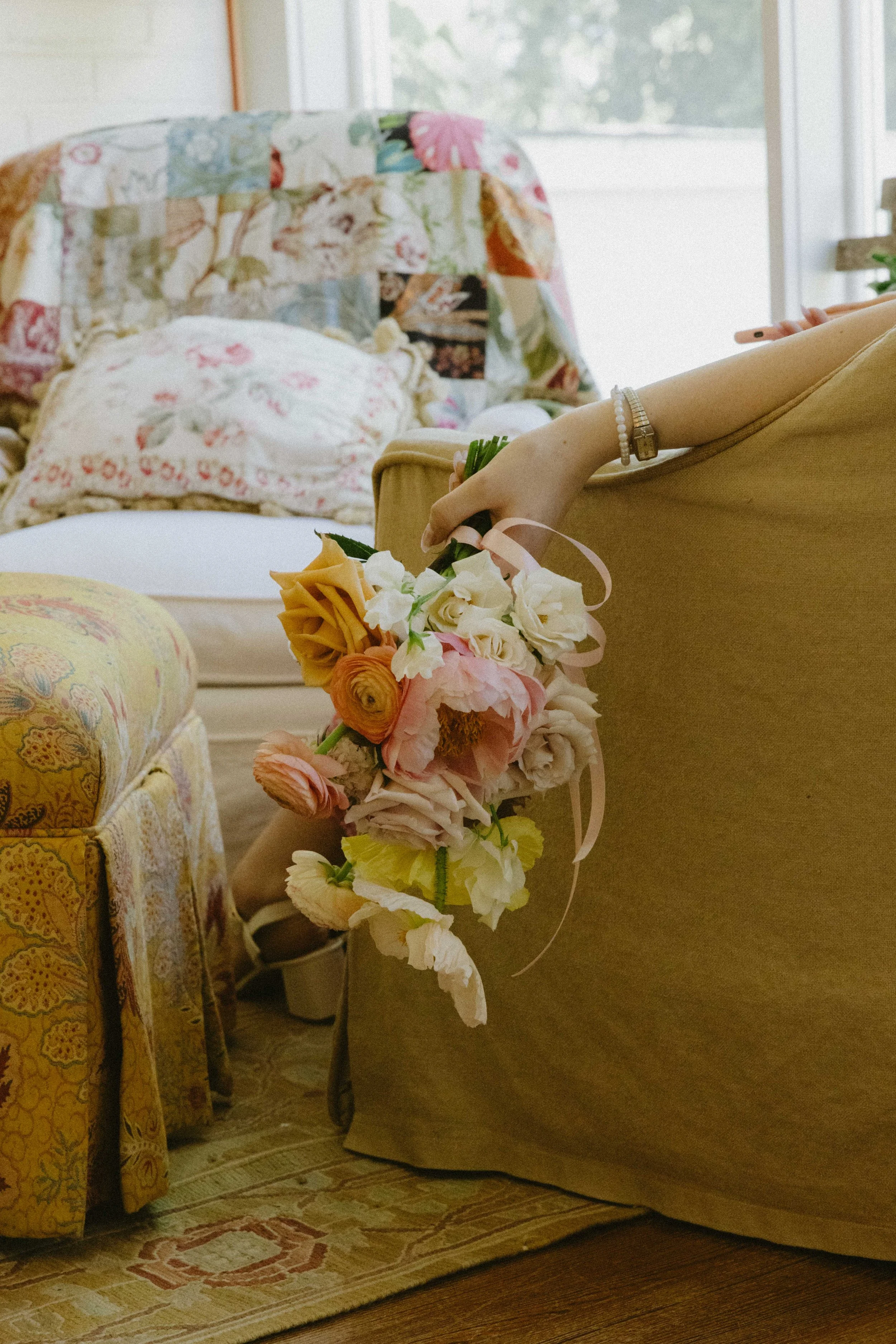 Bridesmaid taking a break on a chair with her flowers