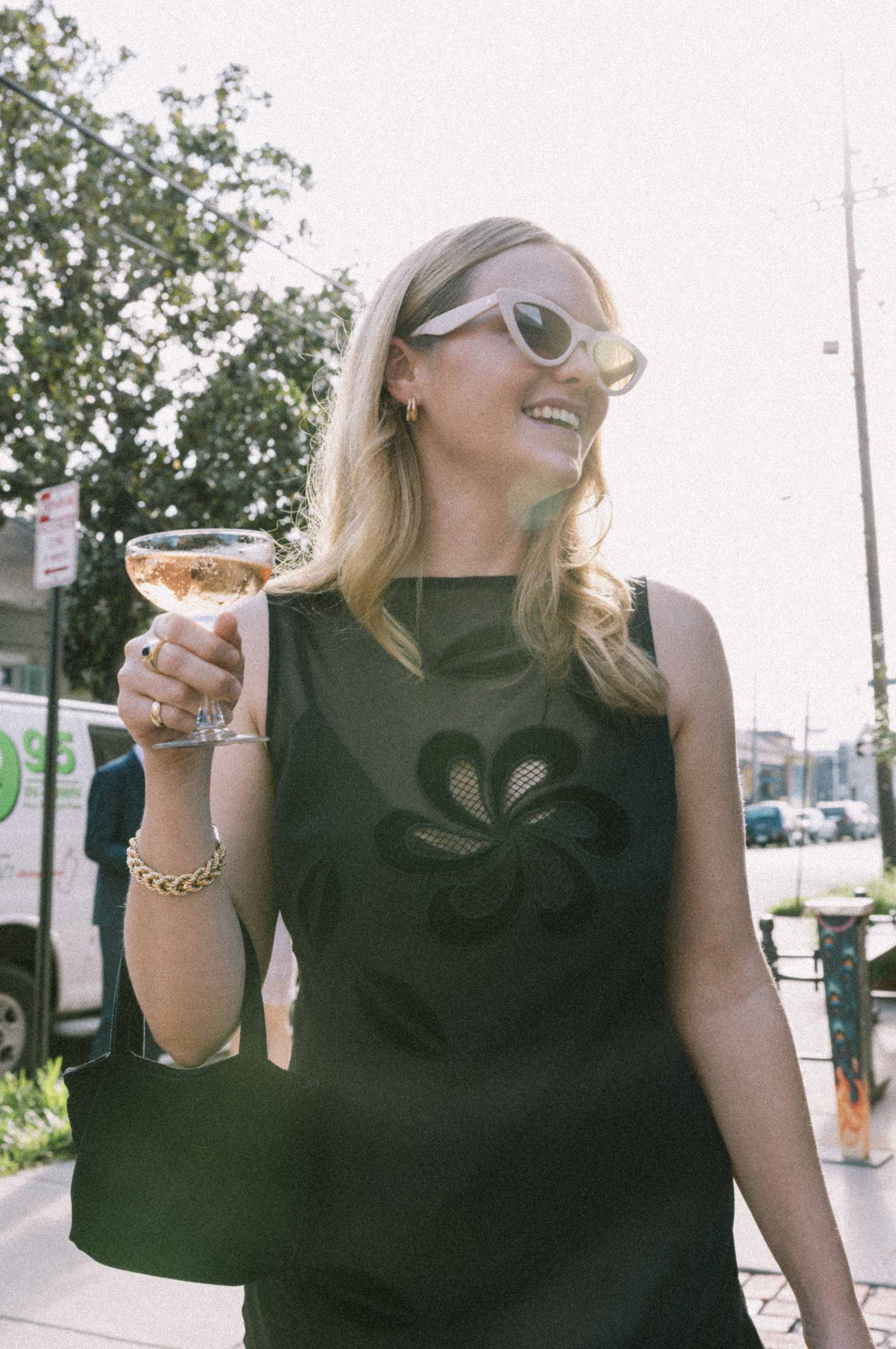 Wedding guest flaunting her drink during cocktail hour