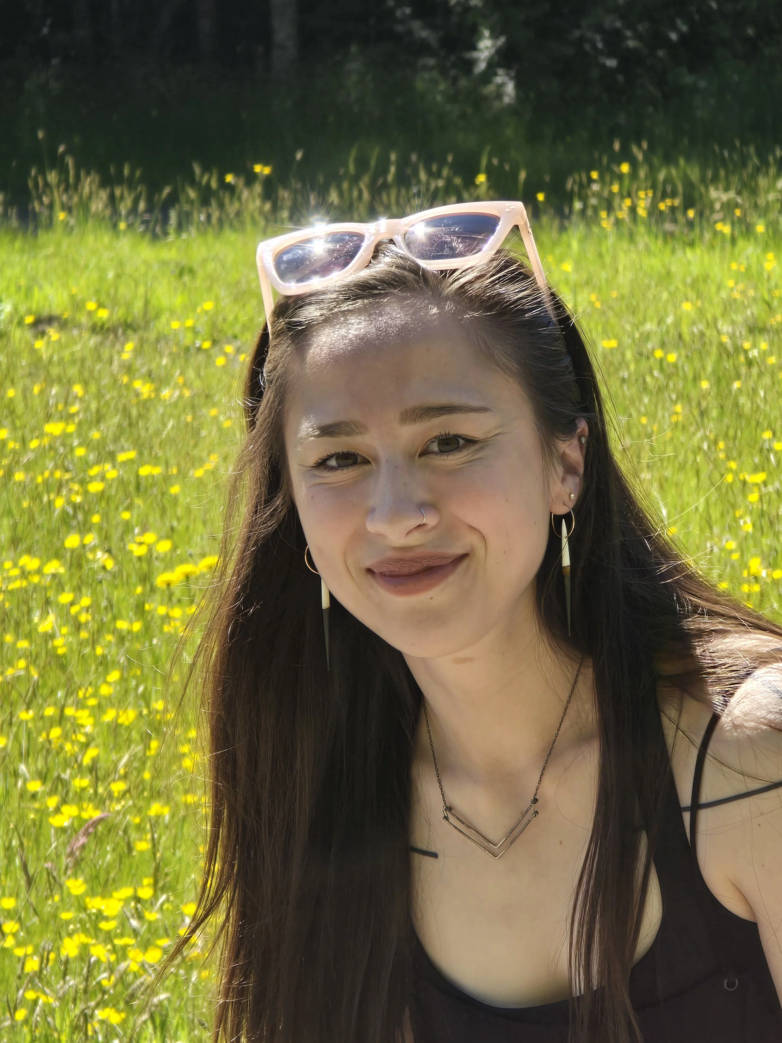 Michayla King serves on the Board of Language Teacher Toolbox, a non-profit society in British Columbia. Michayla is pictured in field of yellow flowers..