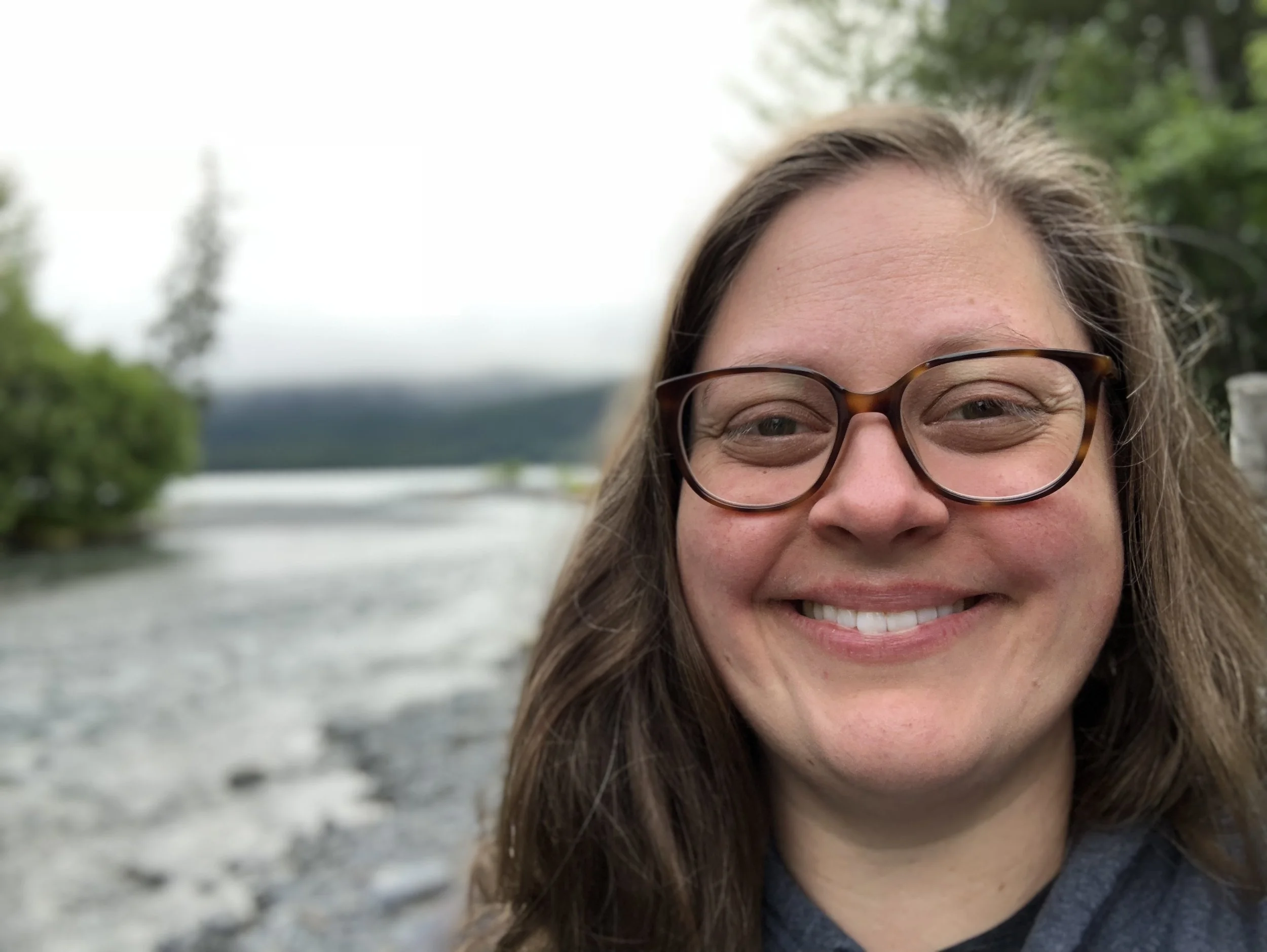 Susanna Ciotti serves on the Board of Language Teacher Toolbox, a non-profit society in British Columbia. Susanna is pictured in front of a river.