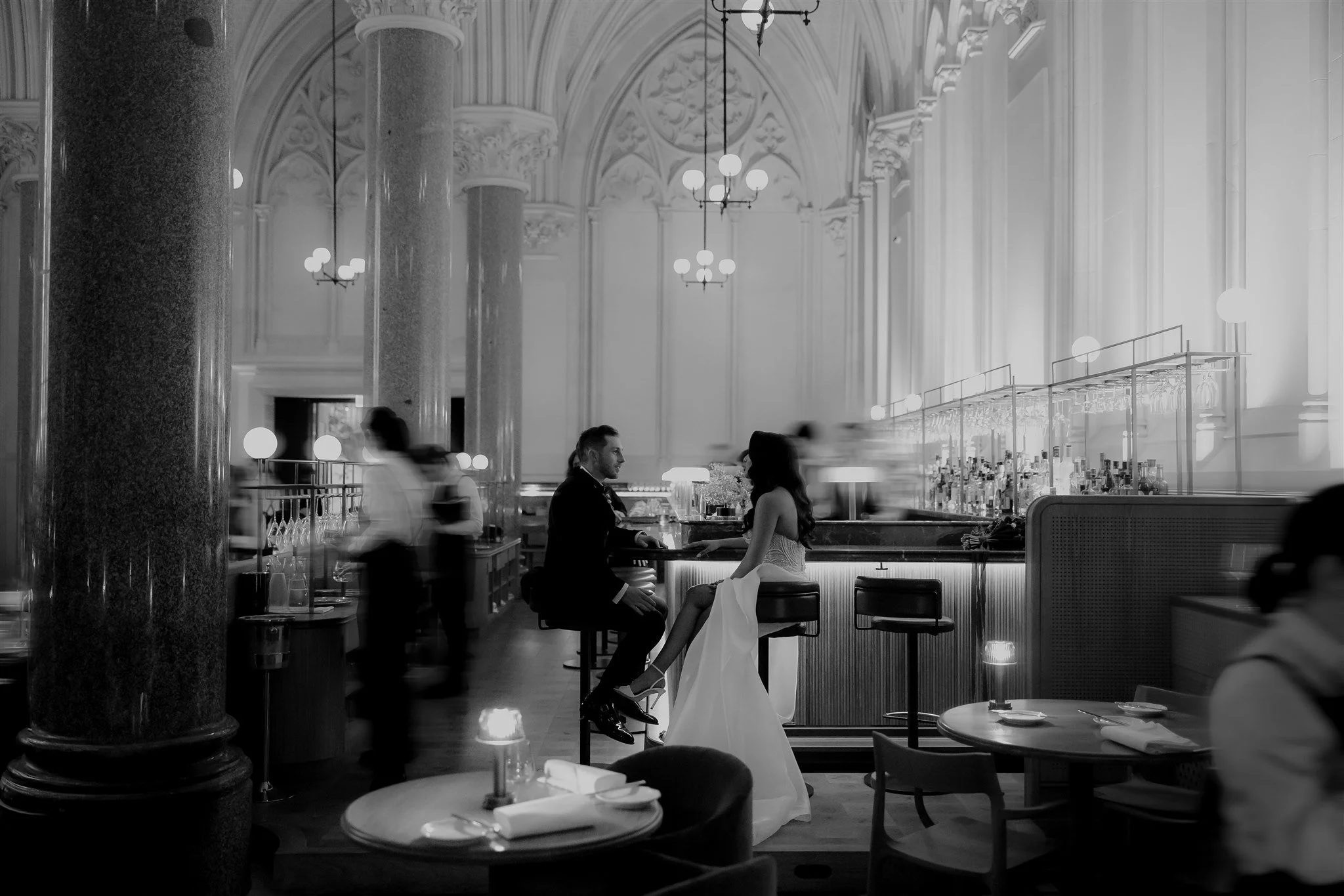 Elegant restaurant with a couple sitting at the bar, black and white