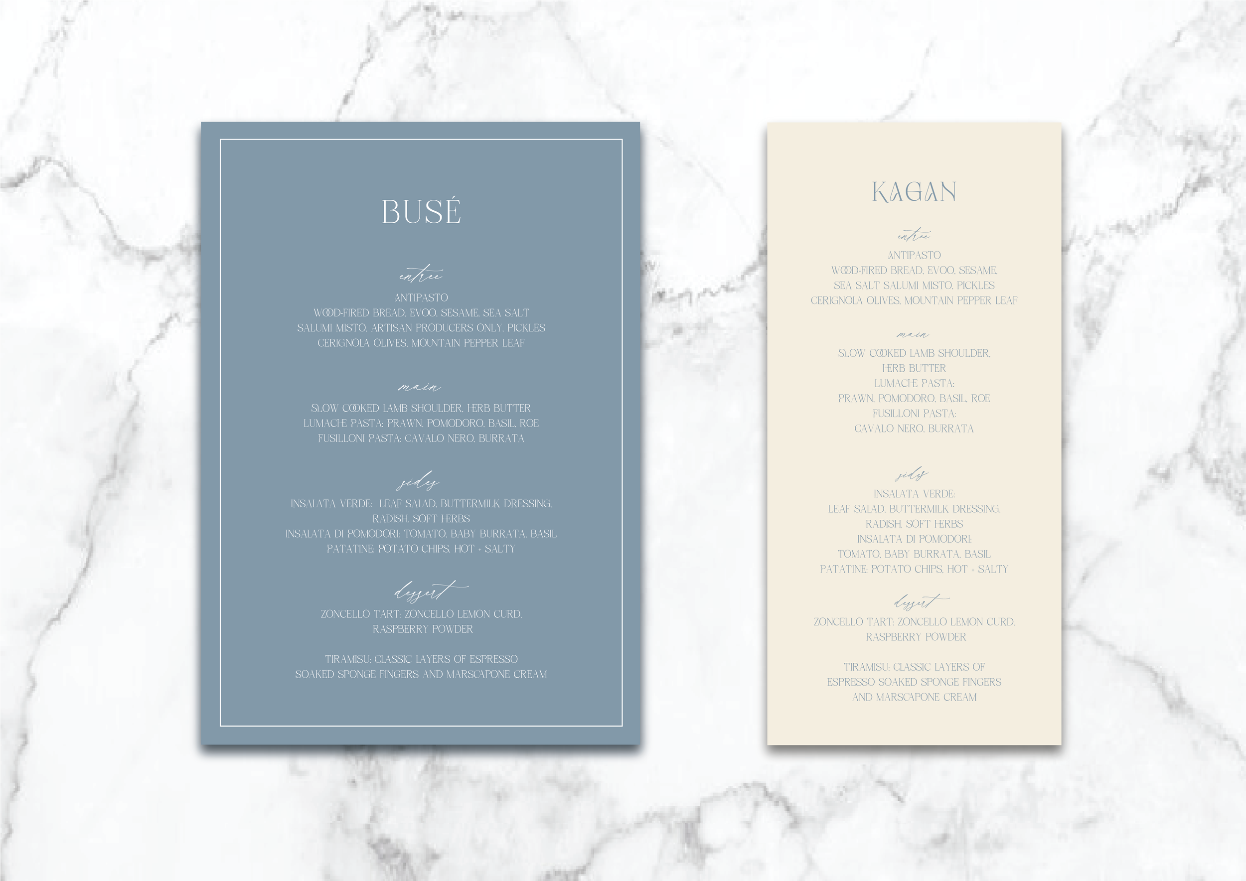 Two elegant wedding menus on a marble background, one blue and one cream, with headings and menu items listed, including antipasto, main courses, salads, and desserts, in a sophisticated font style.