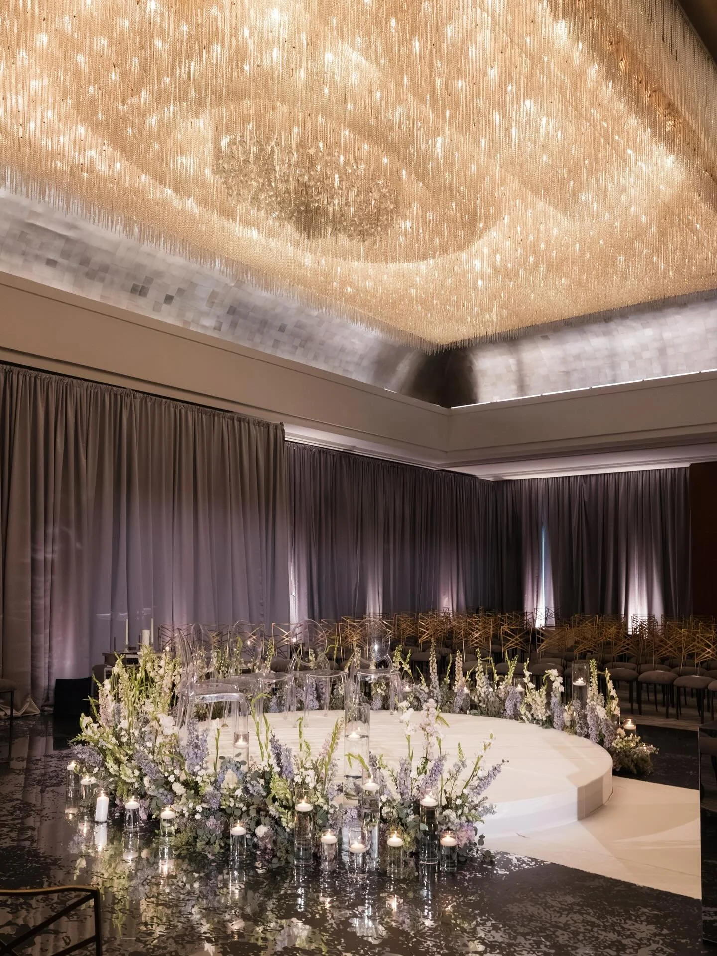 A few ceremony details from Chicago. This design was a study in light and texture, featuring an elevated central platform (ceremonies in the round are always fun to photograph), mirrored surfaces, soft candlelight, and draping.

Looking forward to an