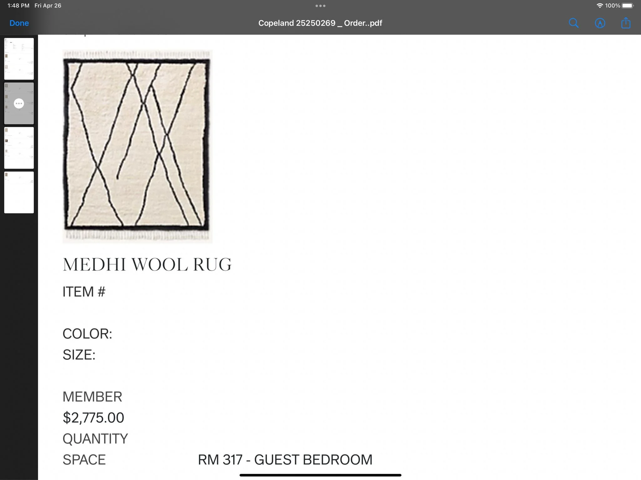 A beige wool rug with black intersecting lines forming a geometric pattern.