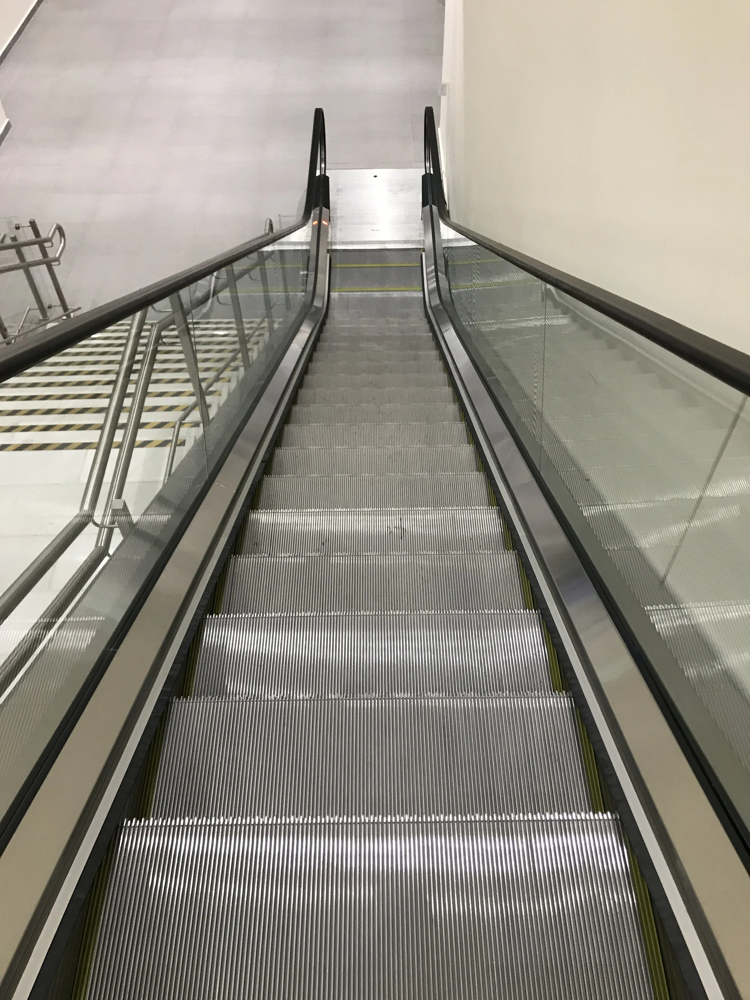 View from top of an escalator looking down.