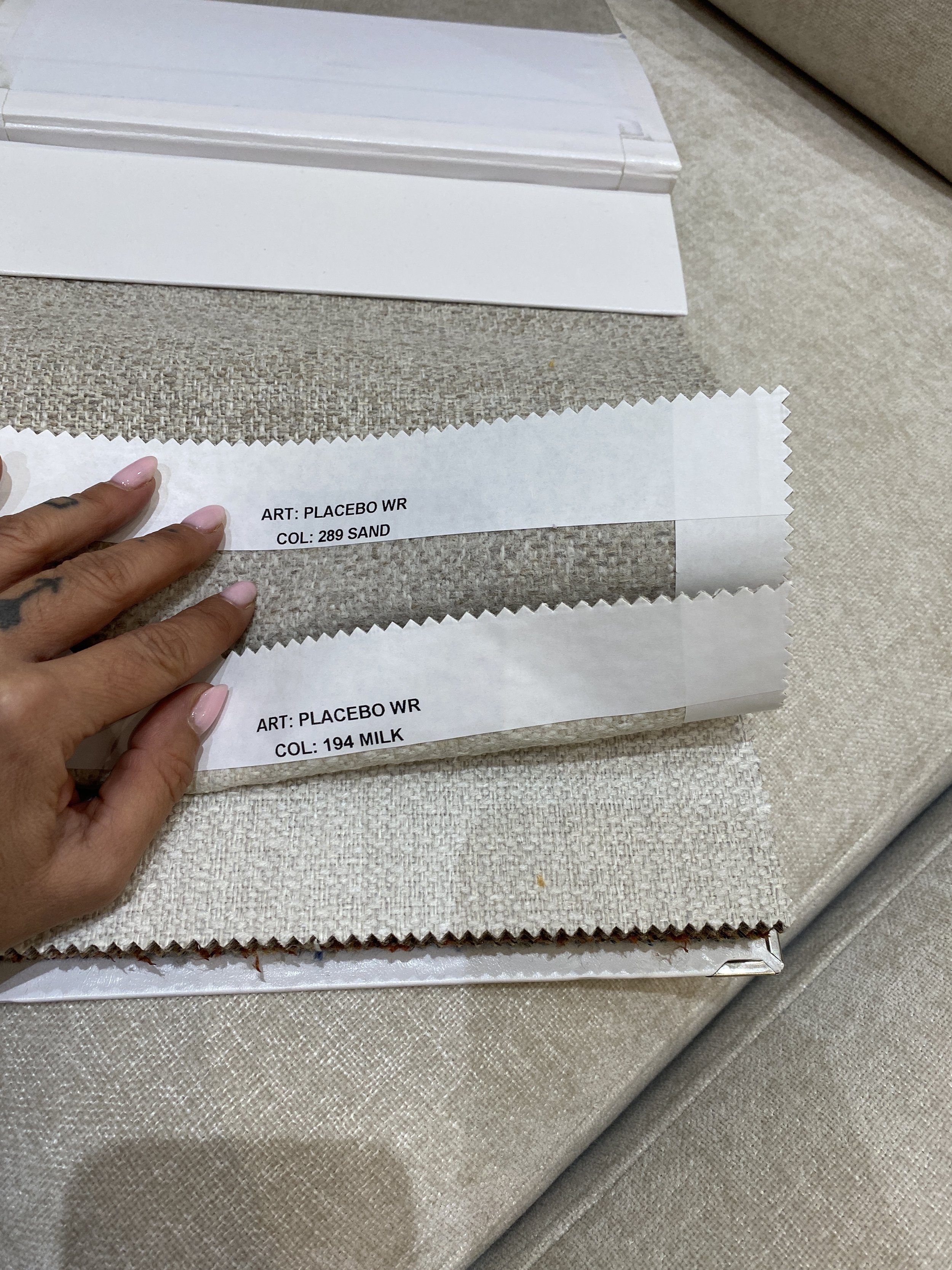 Fabric swatches with labels indicating art and color codes for 'PLACEBO WR' in sand and milk colors.
