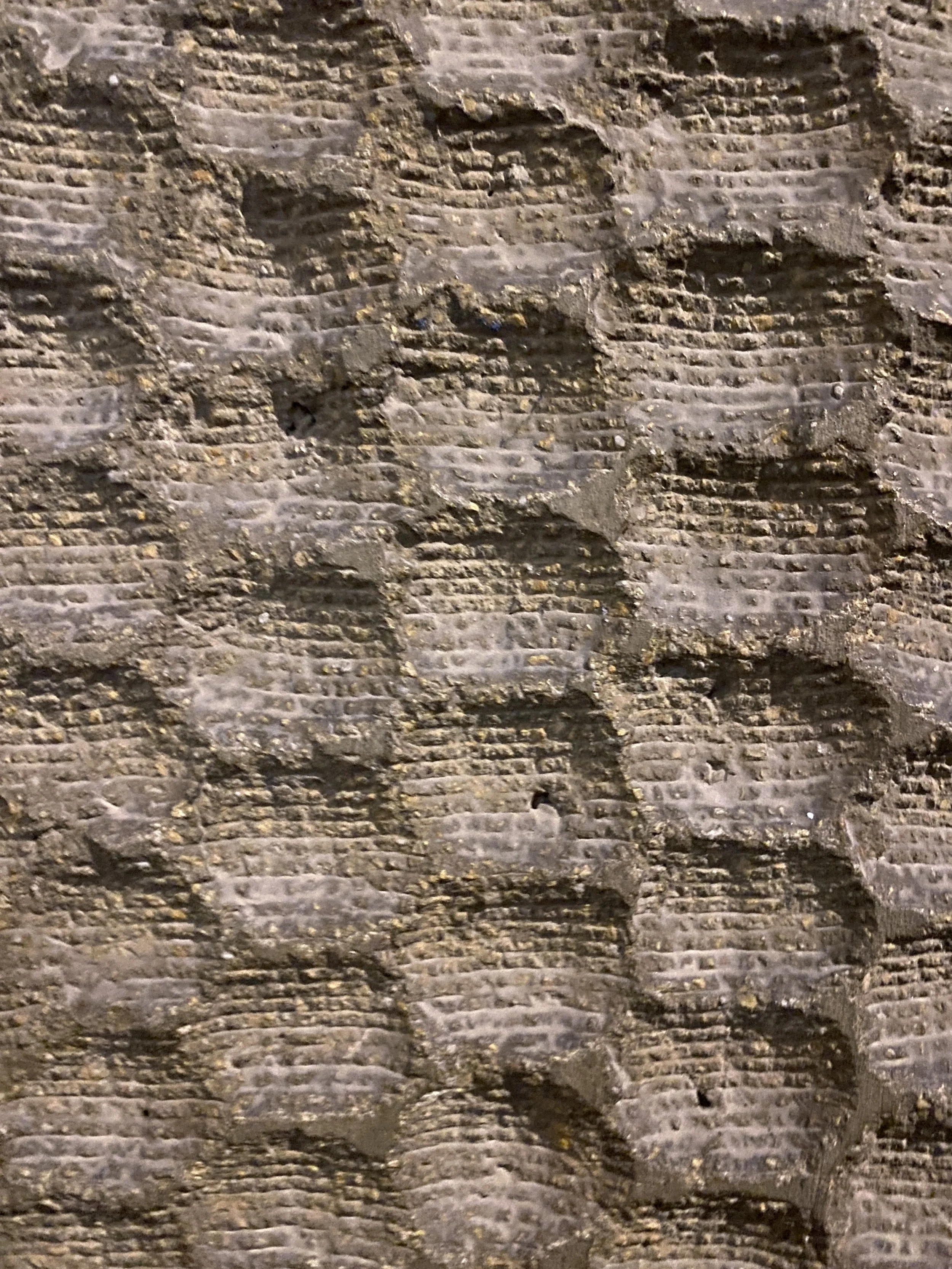Close-up of old brick wall with worn and uneven surface.