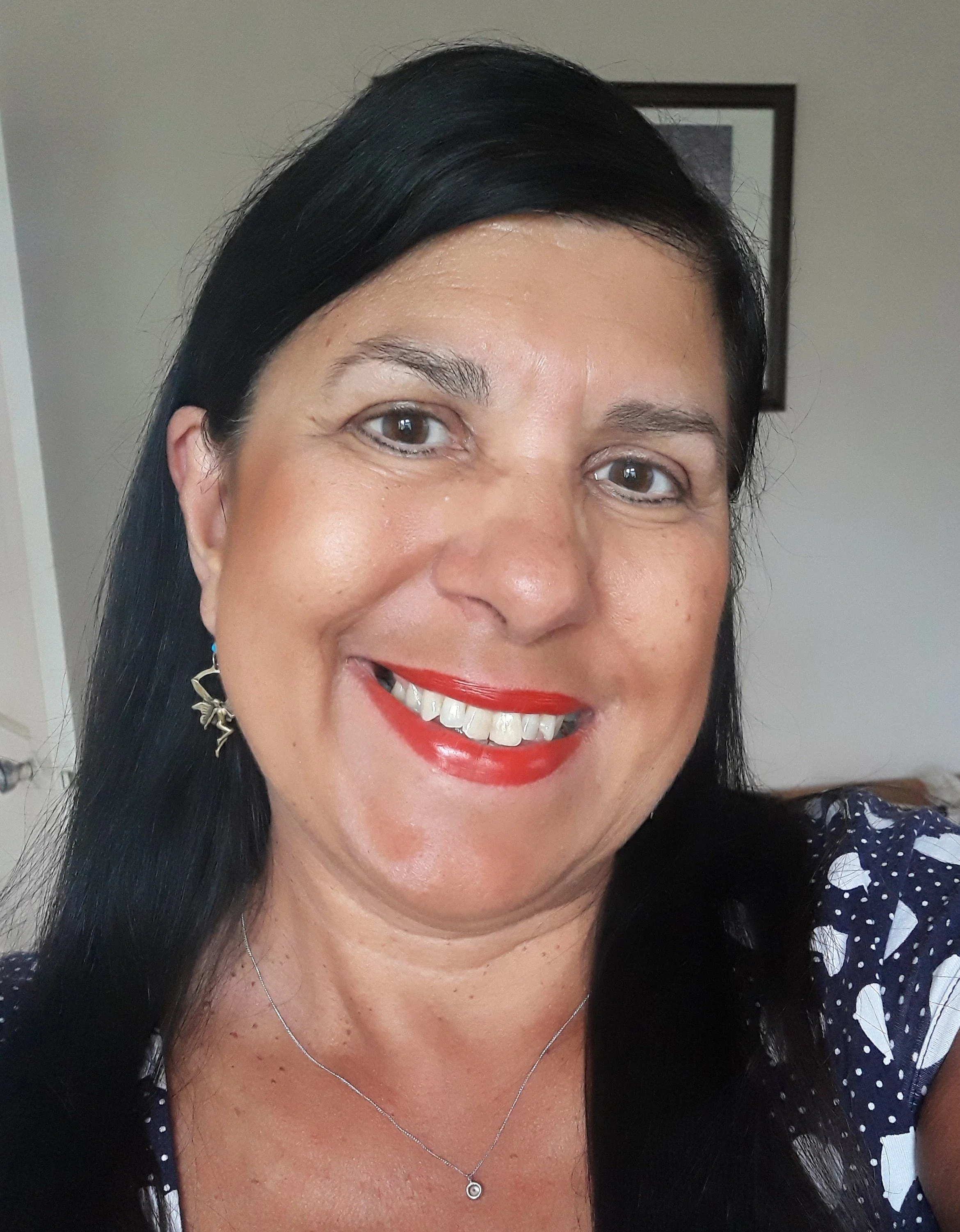 Female with light brown skin tone and black hair and brown eyes.