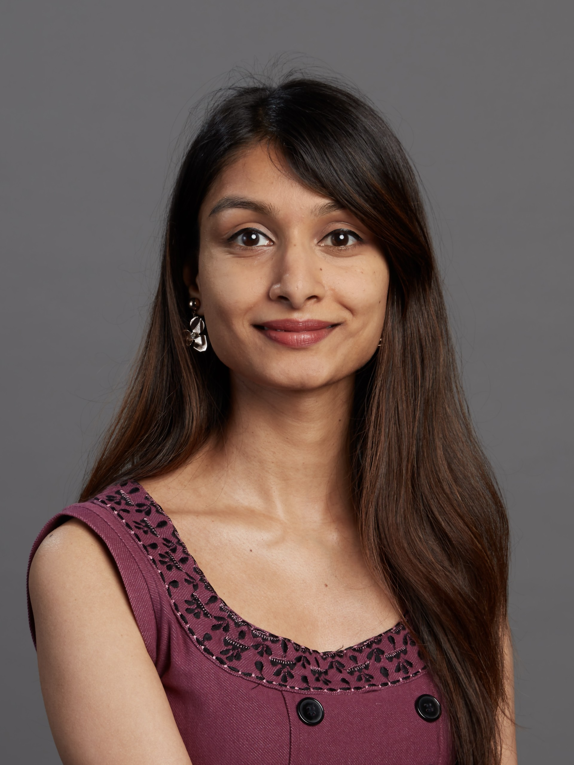 Female with brown skin tone, brown eyes and brown hair.