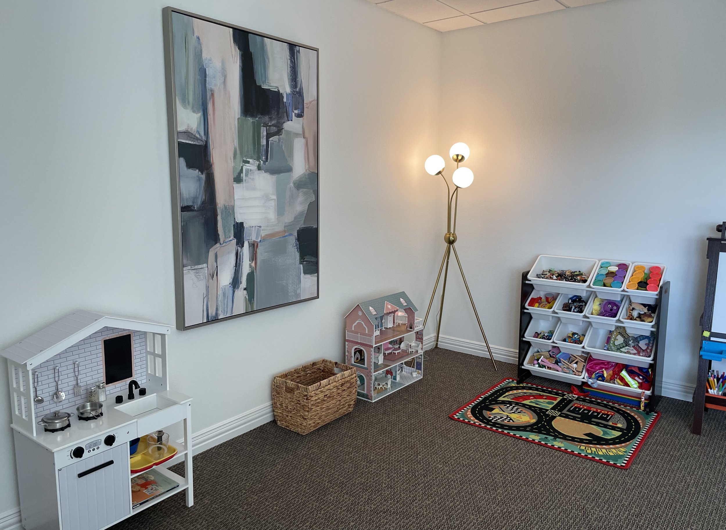 Play therapy room at Clarion Therapy & Wellness in Rockwall, TX featuring child-friendly toys, dollhouse, and creative play space.