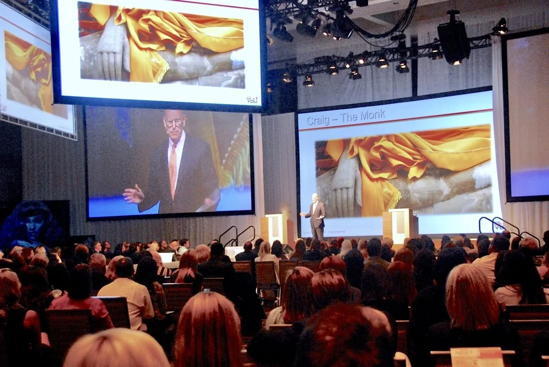 Craig speaking on stage in front of a large audience