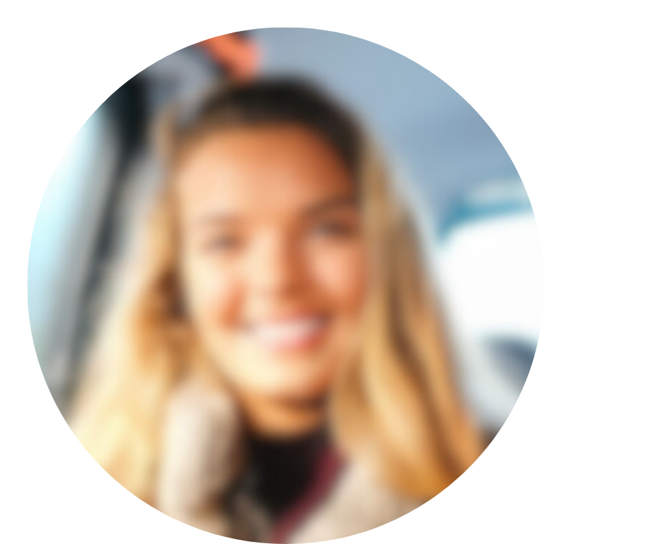 Blurry portrait of a person with long hair, smiling.