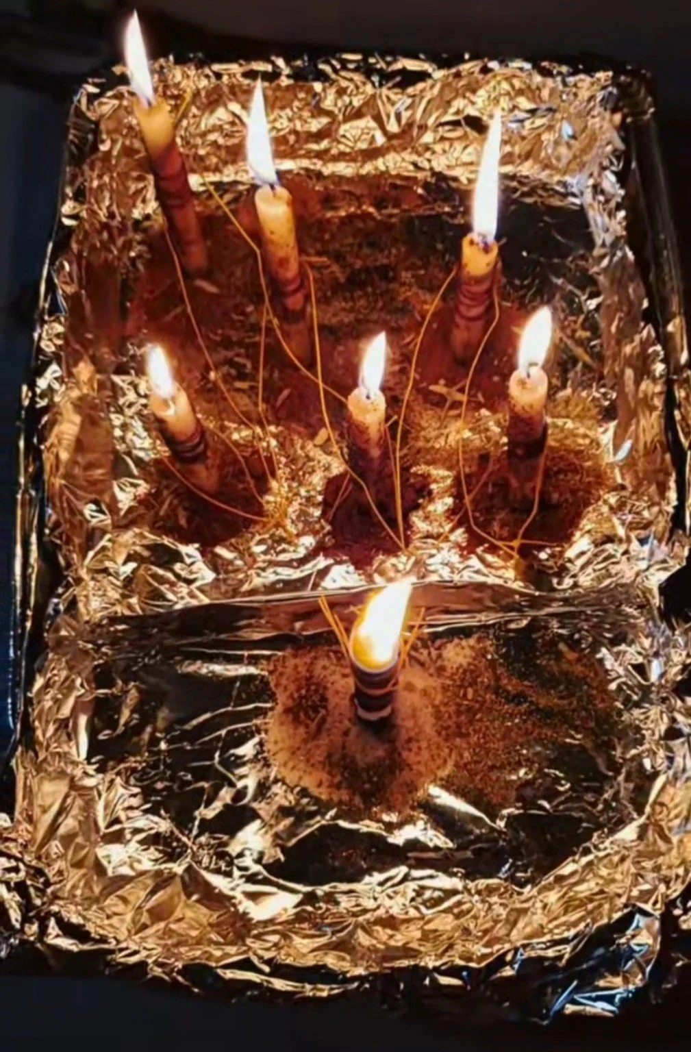 Cord cutting ritual with burning candles, cord, herbs, and fire for spiritual release and energetic separation.