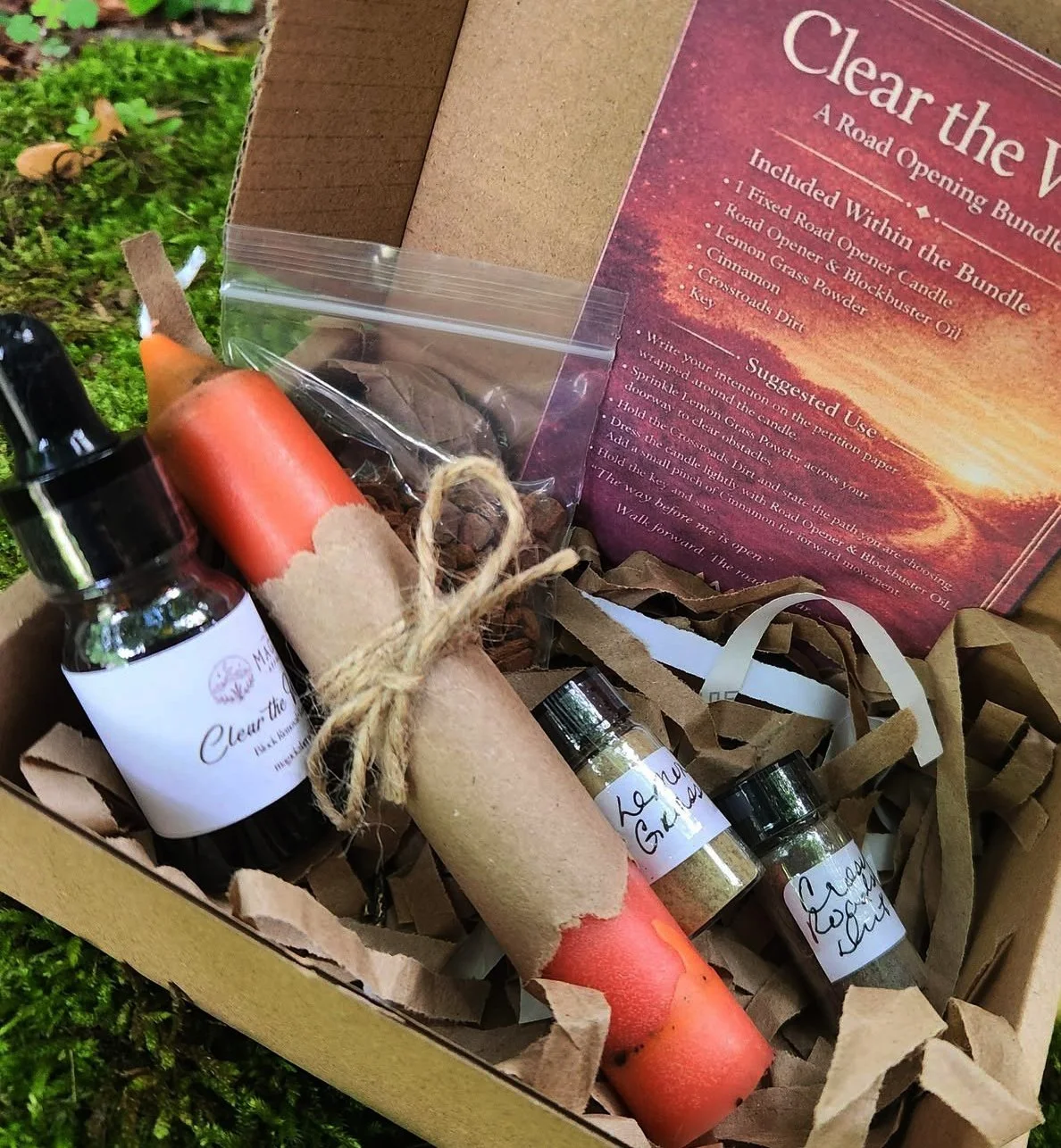 Clear The Way Road Opener Spell Bundle Kit with fixed candle, Road Opener oil, lemongrass powder, cinnamon, crossroads dirt, and key
