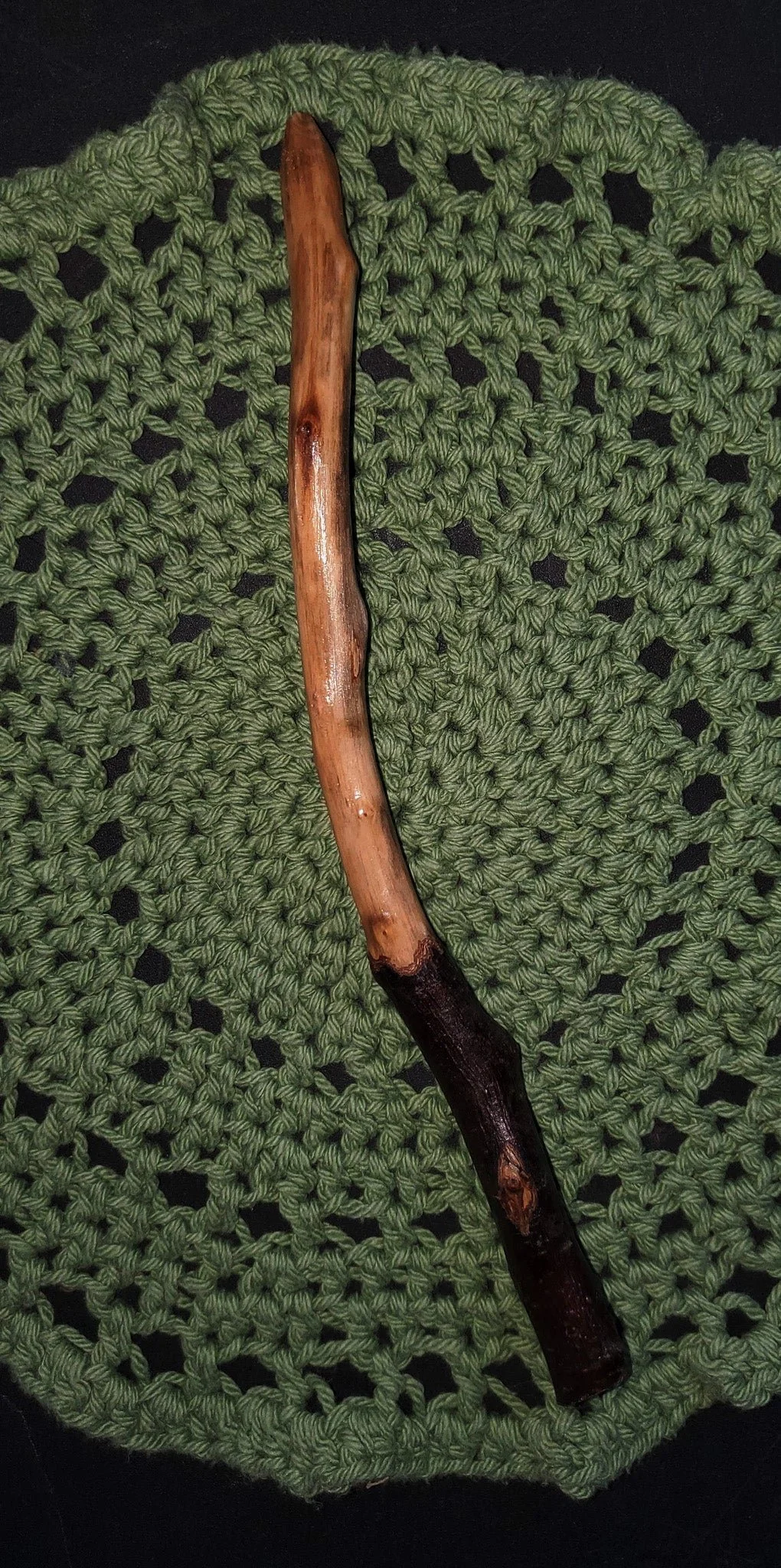 Wildwood Holler Wand #16, an Appalachian foraged wood ritual wand with a dark natural handle, warm polished upper body, curved shape, and pointed tip.