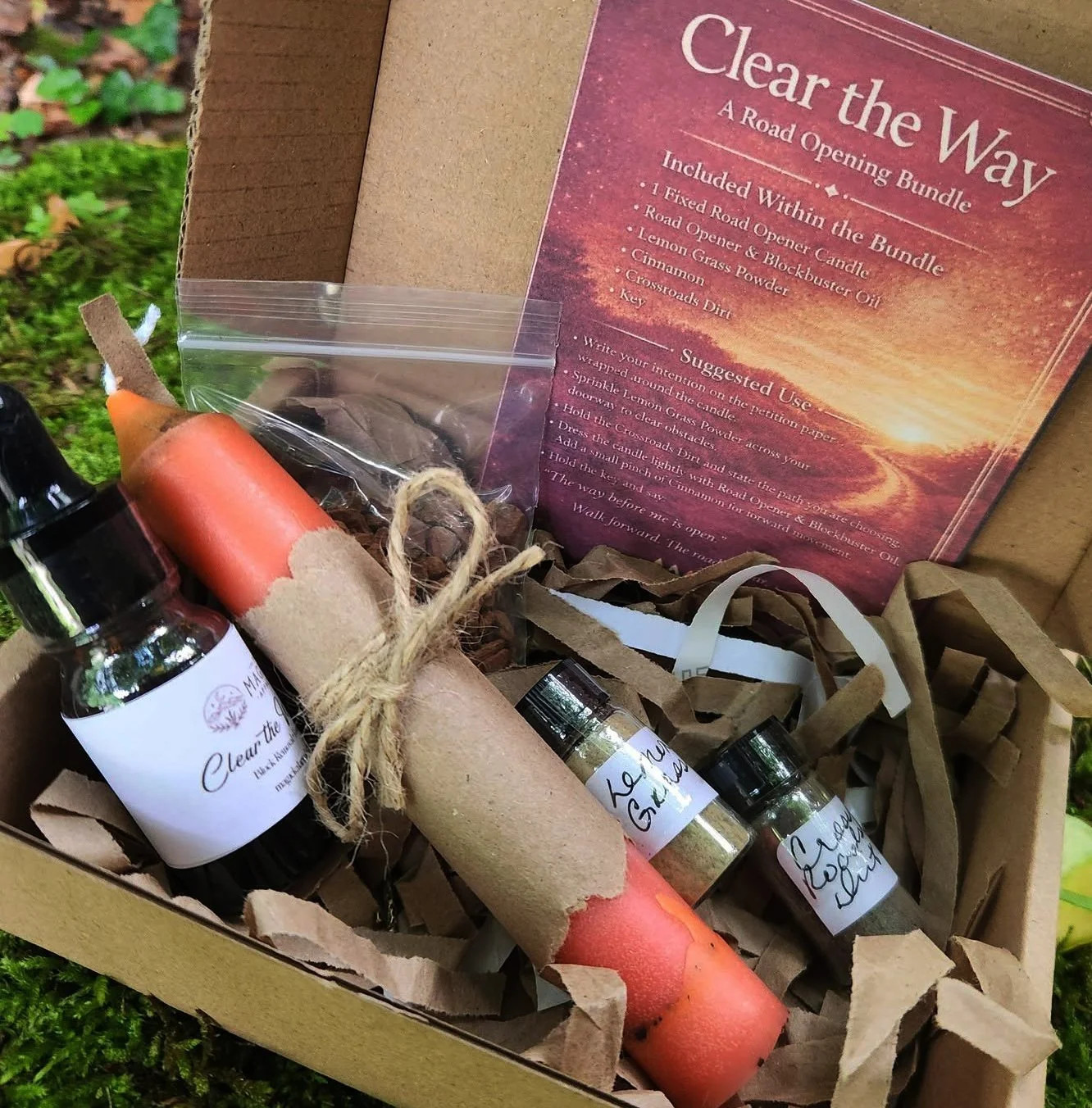 Clear The Way Road Opener Spell Bundle Kit with fixed candle, Road Opener oil, lemongrass powder, cinnamon, crossroads dirt, and key