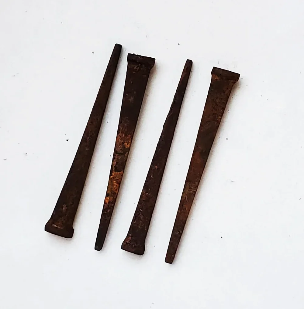 Rusted iron coffin nails used in folk magic for endings, banishing, binding, and spiritual protection