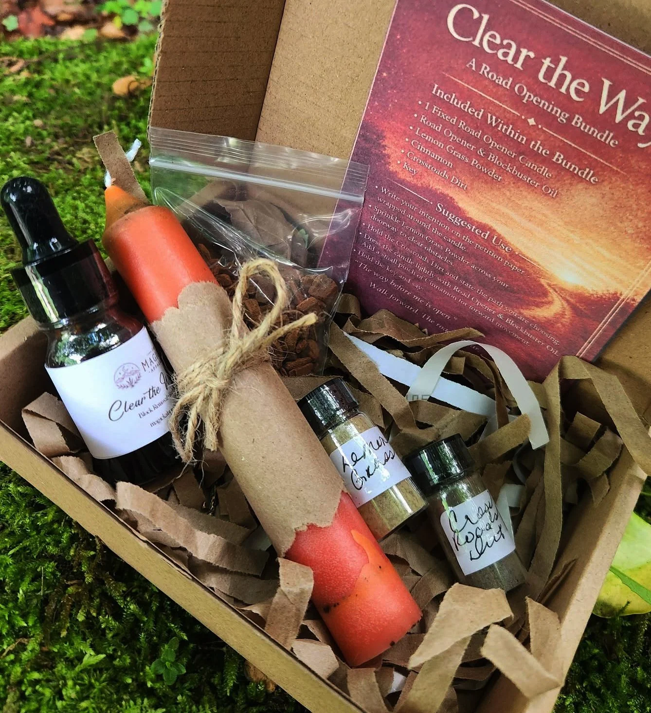 Clear The Way Road Opener Spell Bundle Kit with fixed candle, Road Opener oil, lemongrass powder, cinnamon, crossroads dirt, and key