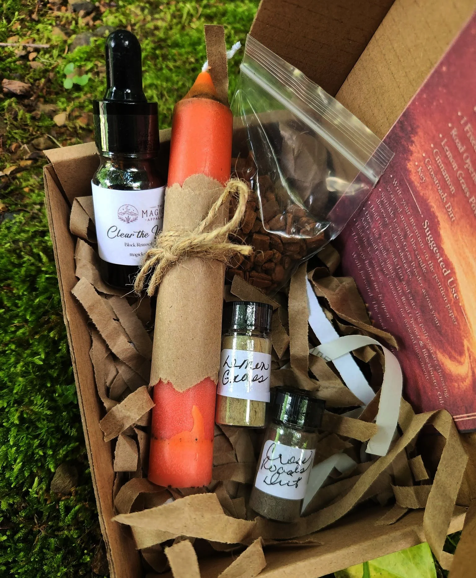 Clear The Way Road Opener Spell Bundle Kit with fixed candle, Road Opener oil, lemongrass powder, cinnamon, crossroads dirt, and key