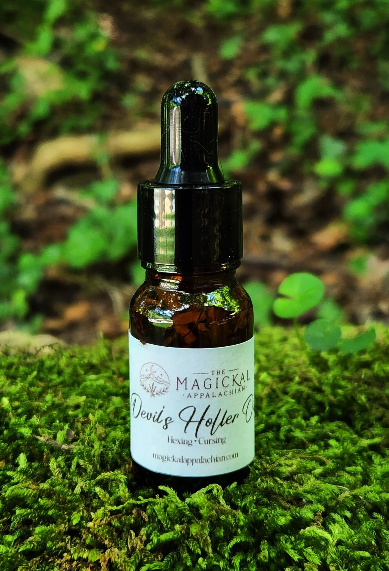 A potent hexing and cursing oil crafted for curse work, reversal work, enemy work, candle dressing, petitions, jars, and baneful spiritual workings.