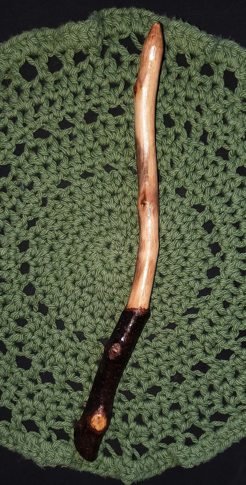 Wildwood Holler Wand #16, an Appalachian foraged wood ritual wand with a dark natural handle, warm polished upper body, curved shape, and pointed tip.