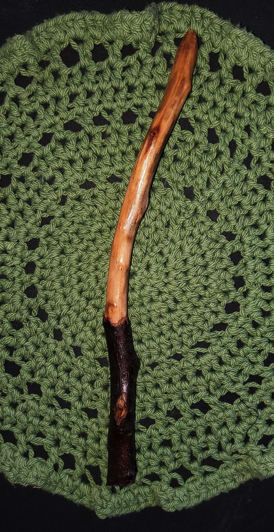 Wildwood Holler Wand #16, an Appalachian foraged wood ritual wand with a dark natural handle, warm polished upper body, curved shape, and pointed tip.