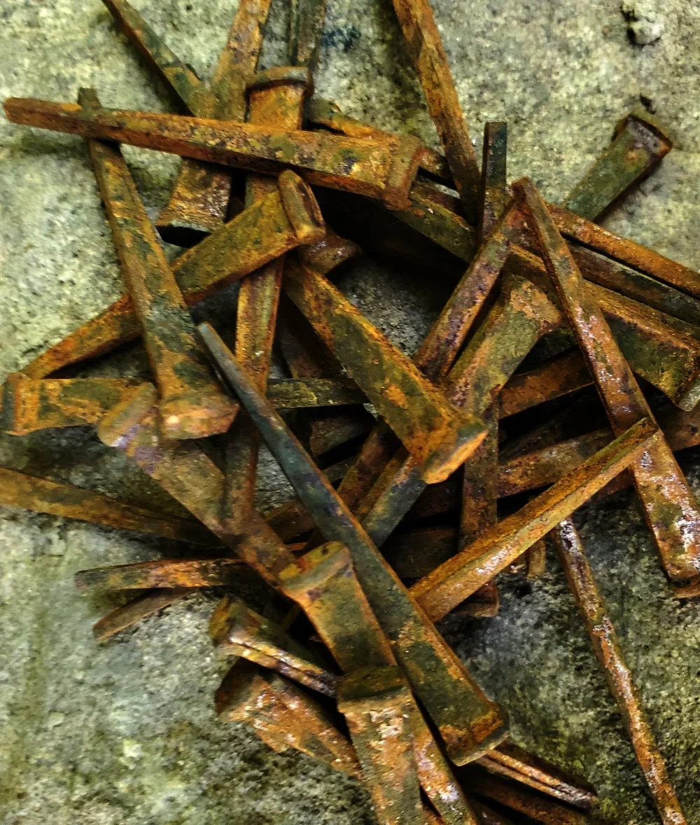 Rusted iron coffin nails used in folk magic for endings, banishing, binding, and spiritual protection