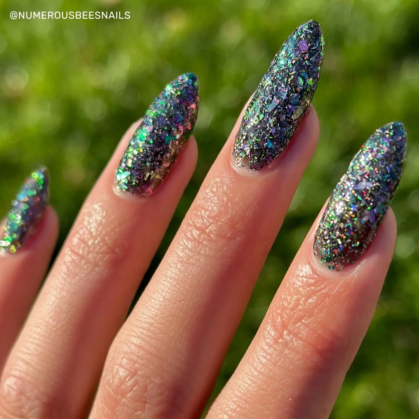 ABSTRACT EXPRESSIONISM:
A black jelly base with green/pink ultra chrome flakes, large holo flakes, pink metallic flakes, green metallic flakes, and various size silver holo.

This polish is textured.
Recommend a peel off base coat, 1 coat glitter smo