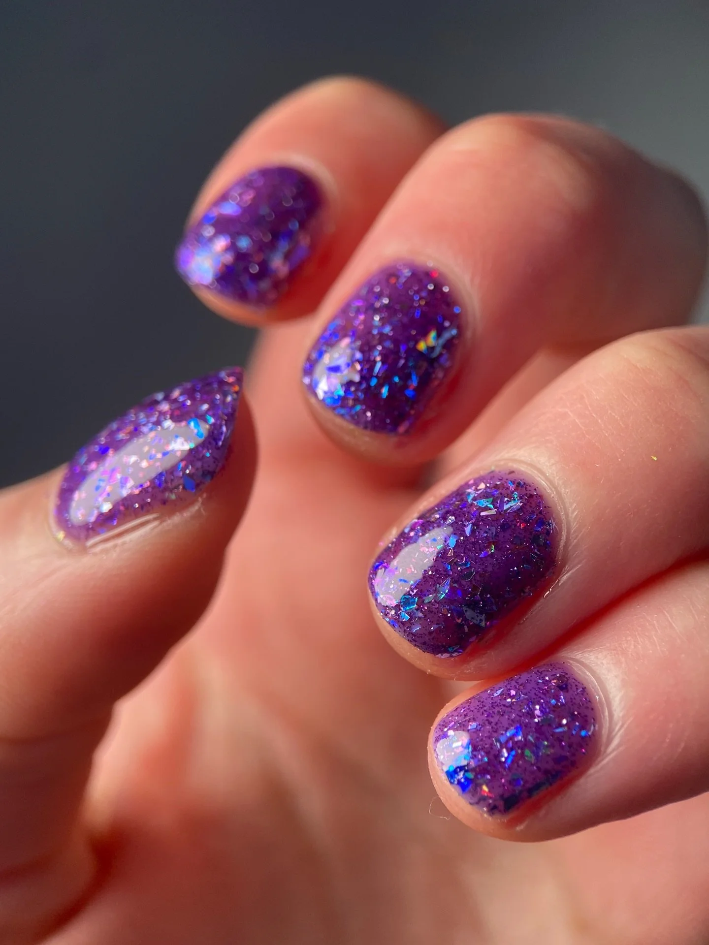 TWILIGHT BLOOMS
Purple jelly base, teal/purple &amp; blue/violet/purple color shifting flakies, violet holo micro shreds, denim blue and pink holo flakes, purple reflective glitter

Swatched by @katie_scheid_art 
Paid PR

#fauvecosmetics #nailpolish 