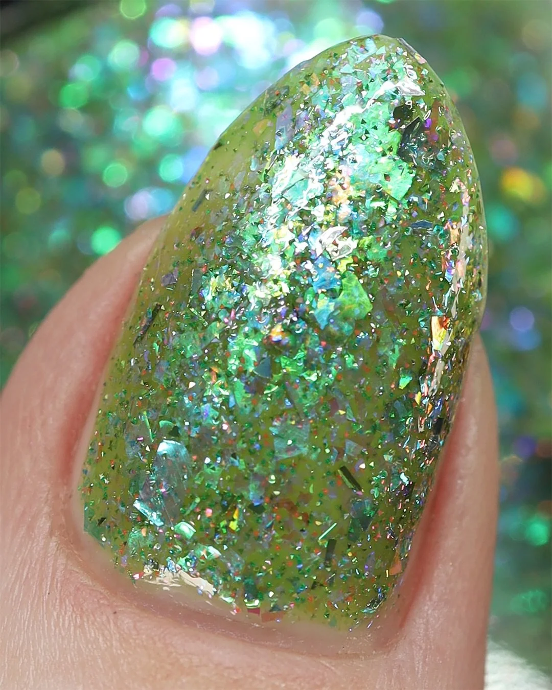 WATER GARDEN
Mossy green jelly base, aqua/blue iridescent flakies, violet/pink/orange iridescent flakies, blue/violet iridescent flakies, sage and denim blue holo flakes, blue/purple/pink reflective glitter, baby blue holo

Swatched by @lacqueredwall