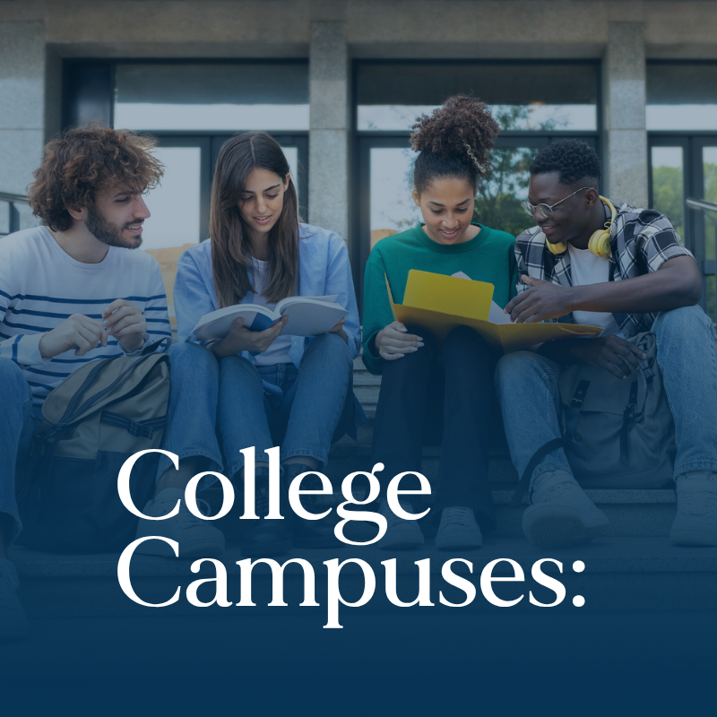 Four students sit together on college campus steps, reading and showing the importance of mental health programs for universities.